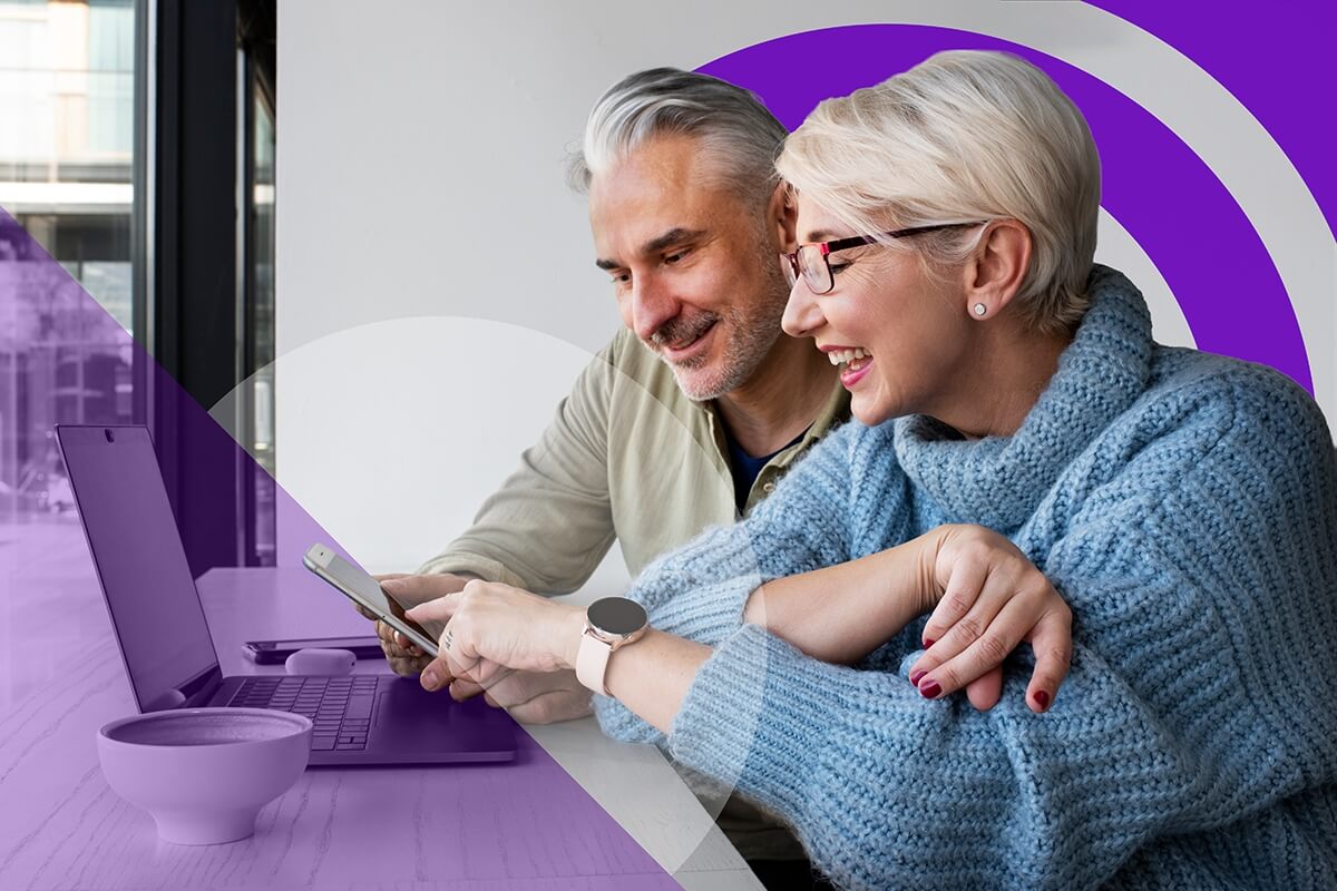 An elderly couple looking at their devices.